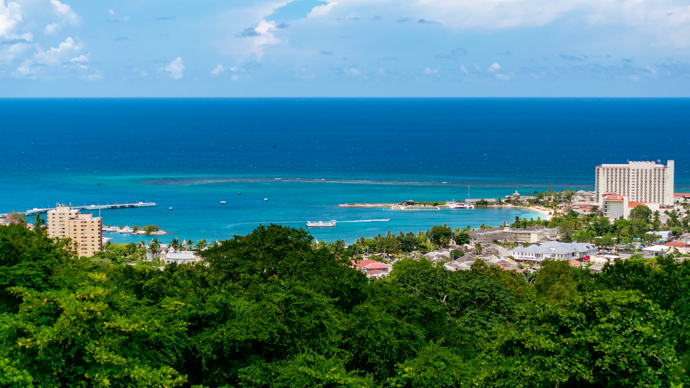 Turquoise Jamaican bay with green hills
